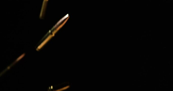 .300 AAC Blackout And 9mm Luger Bullets Dropping In Slow Motion. Firearms Cartridges. studio shot