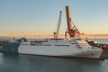 Mega LNG powered car, passengers pax and cargo transporter ro-ro ferry ship cruiseship cruise liner in Barcelona port, Spain with harbor and city skyline	