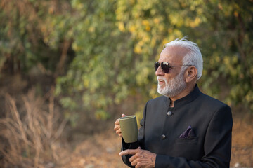 Fototapeta premium A senior businessman is having a coffee on his coffee break