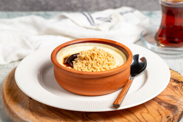 Rice pudding. Milky dessert. Oven-baked rice pudding dessert in a clay bowl