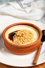 Rice pudding. Milky dessert. Oven-baked rice pudding dessert in a clay bowl. Close up