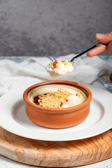 Rice pudding. Milky dessert. Oven-baked rice pudding dessert in a clay bowl