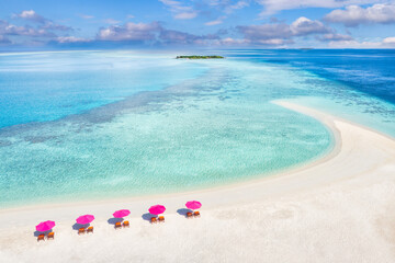 Aerial view of white sandy beach, loungers beach umbrella close to turquoise sea water and lagoon....