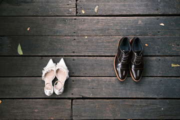 The bride and groom's shoes, two pairs in total, were placed side by side on the natural wooden pathway as they waited in front of the ceremony room.