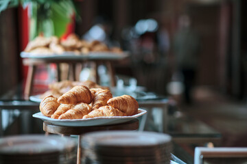 many croissants in many trays awaited to be served to the business conference attendees during the...