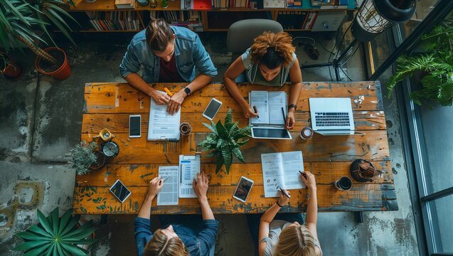 Creative team brainstorming with digital tablets, infusing technology in strategy