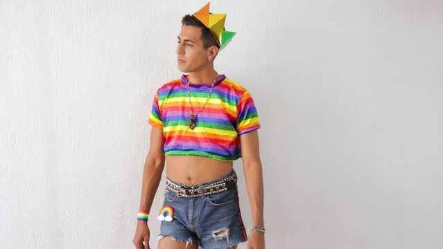 happy young man posing to celebrate lgbtq pride in pride rainbow color croptop