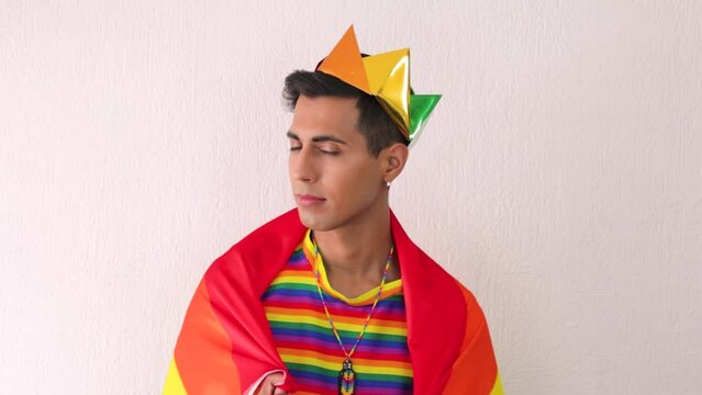 Young serious man celebrating lgbtq pride posing at camera