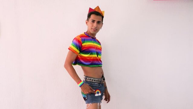 Effeminate homosexual man posing in shorts on a white background. Slow motion