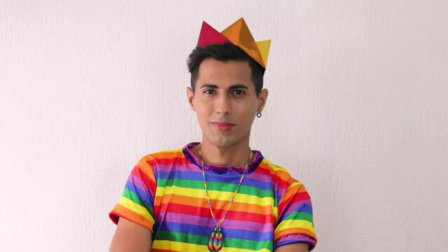 Young beardless homosexual man smiling at camera in lgbtq pride