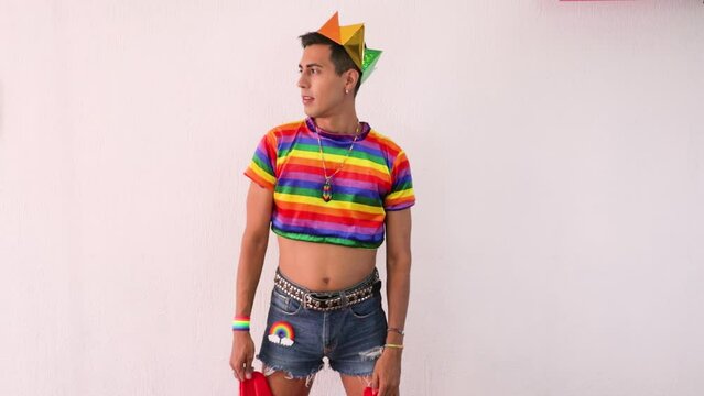 Gay effeminate guy putting the gay flag on his back. Slow motion