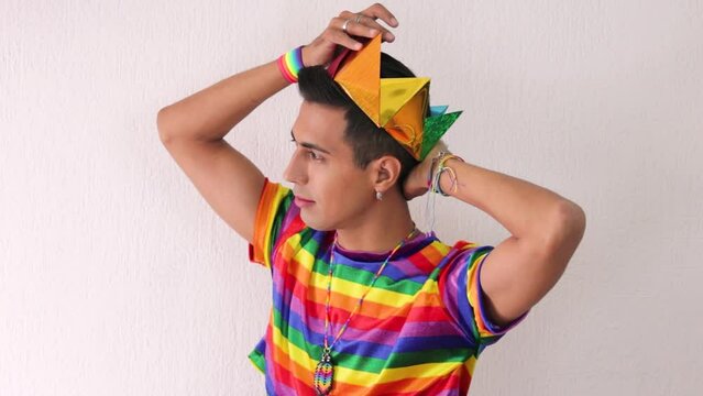 Young homosexual beardless man donning a crown celebrating gay pride