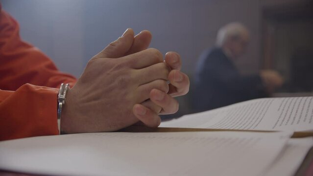 Worried inmate during a court date fretting with lawyer