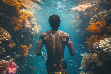 Fotobehang African man in a mask swims on a coral reef © sofiko14