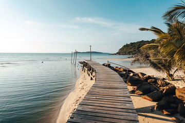 Wooden pier by the beach and clear blue water on the island