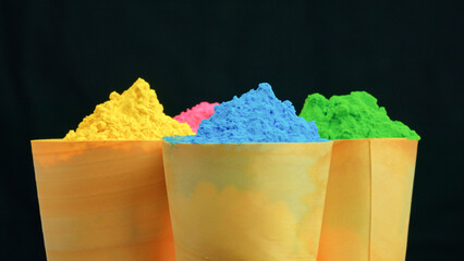 Color Powder Cups On Black For Holi Festival