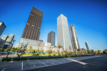 Naklejka premium Reflection of Skyscrapers on Car in Urban Business Area