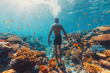  Asian man in a mask swims on a coral reef © sofiko14