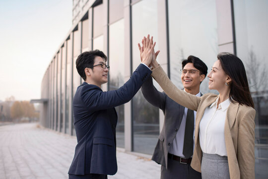 Cheerful business people celebrating outdoors