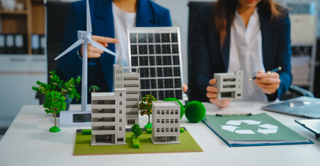Sustainable business meetings at desks, green energy concepts. People in business suits discussing...