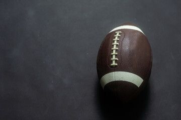American football ball isolated on black background
