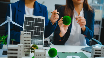 Sustainable business meetings at desks, green energy concepts. People in business suits discussing...