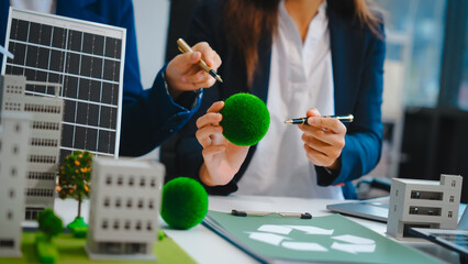 Sustainable business meetings at desks, green energy concepts. People in business suits discussing...