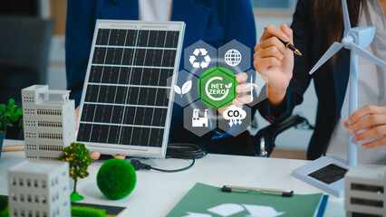 Sustainable business meetings at desks, green energy concepts. People in business suits discussing...