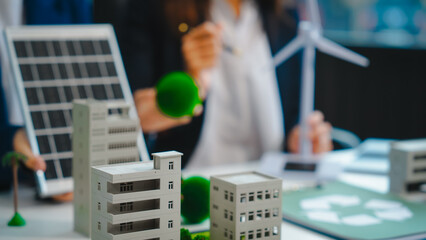 Sustainable business meetings at desks, green energy concepts. People in business suits discussing...