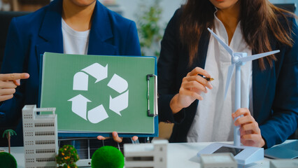 Sustainable business meetings at desks, green energy concepts. People in business suits discussing...