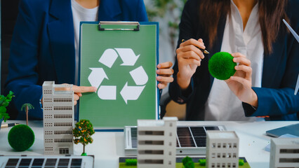 Sustainable business meetings at desks, green energy concepts. People in business suits discussing...