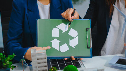 Sustainable business meetings at desks, green energy concepts. People in business suits discussing...