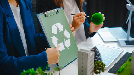 Sustainable business meetings at desks, green energy concepts. People in business suits discussing...