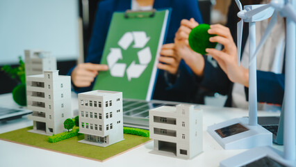 Sustainable business meetings at desks, green energy concepts. People in business suits discussing...