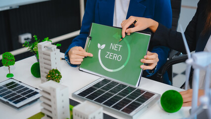 Sustainable business meetings at desks, green energy concepts. People in business suits discussing...
