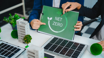 Sustainable business meetings at desks, green energy concepts. People in business suits discussing...