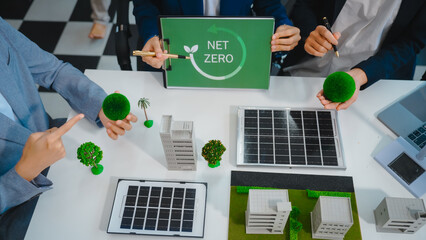 Sustainable business meetings at desks, green energy concepts. People in business suits discussing...