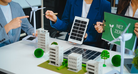 Sustainable business meetings at desks, green energy concepts. People in business suits discussing...