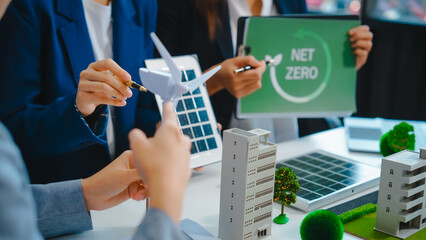 Sustainable business meetings at desks, green energy concepts. People in business suits discussing...