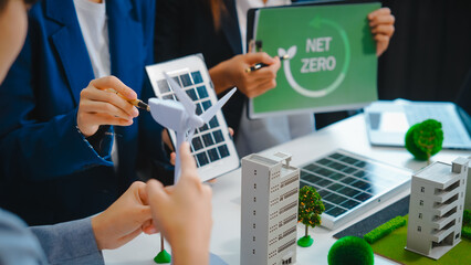 Sustainable business meetings at desks, green energy concepts. People in business suits discussing...