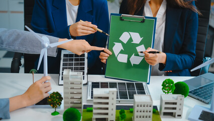 Sustainable business meetings at desks, green energy concepts. People in business suits discussing...