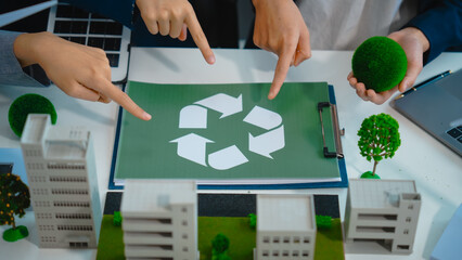 Sustainable business meetings at desks, green energy concepts. People in business suits discussing...