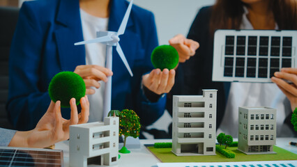 Sustainable business meetings at desks, green energy concepts. People in business suits discussing...