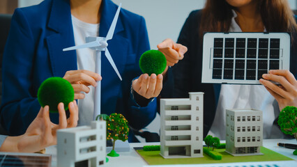 Sustainable business meetings at desks, green energy concepts. People in business suits discussing eco-friendly solutions, solar cells, wind turbines, and promoting net-zero practices.
