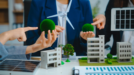 Sustainable business meetings at desks, green energy concepts. People in business suits discussing...