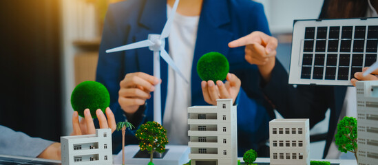 Sustainable business meetings at desks, green energy concepts. People in business suits discussing...