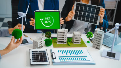 Sustainable business meetings at desks, green energy concepts. People in business suits discussing...