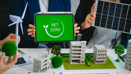 Sustainable business meetings at desks, green energy concepts. People in business suits discussing...