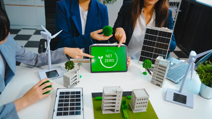 Sustainable business meetings at desks, green energy concepts. People in business suits discussing...