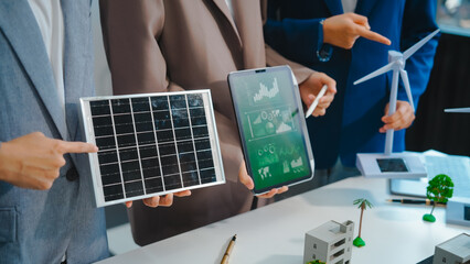 Sustainable business meetings at desks, green energy concepts. People in business suits discussing...